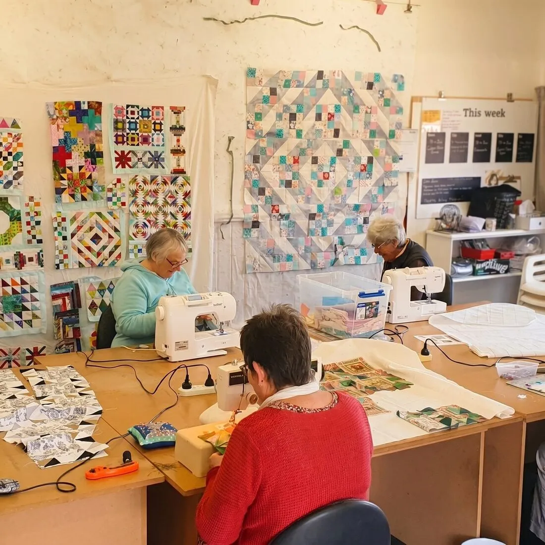 Makers quilting together in the studio